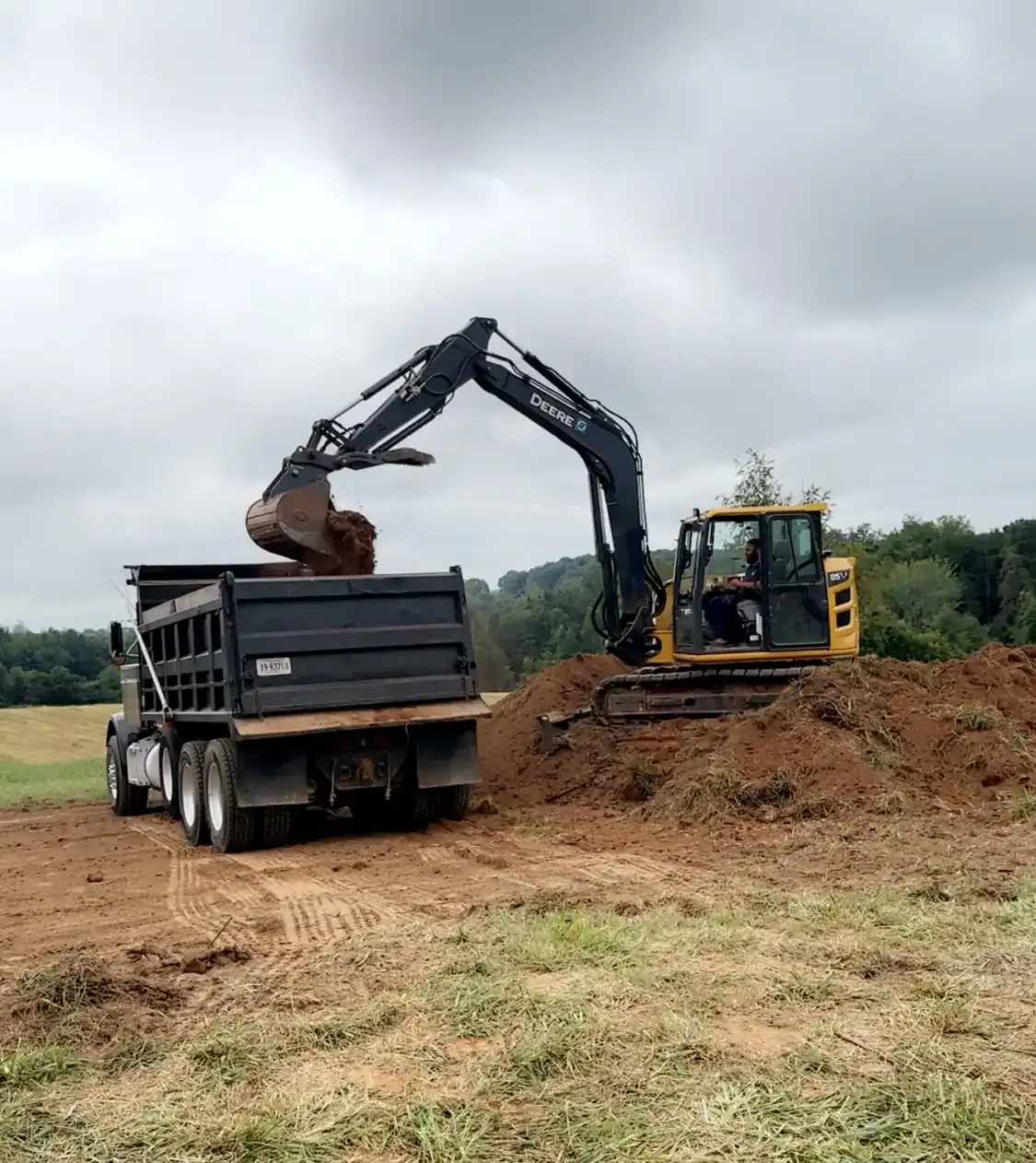 Excavator loading dirt into dump truck near Roanoke