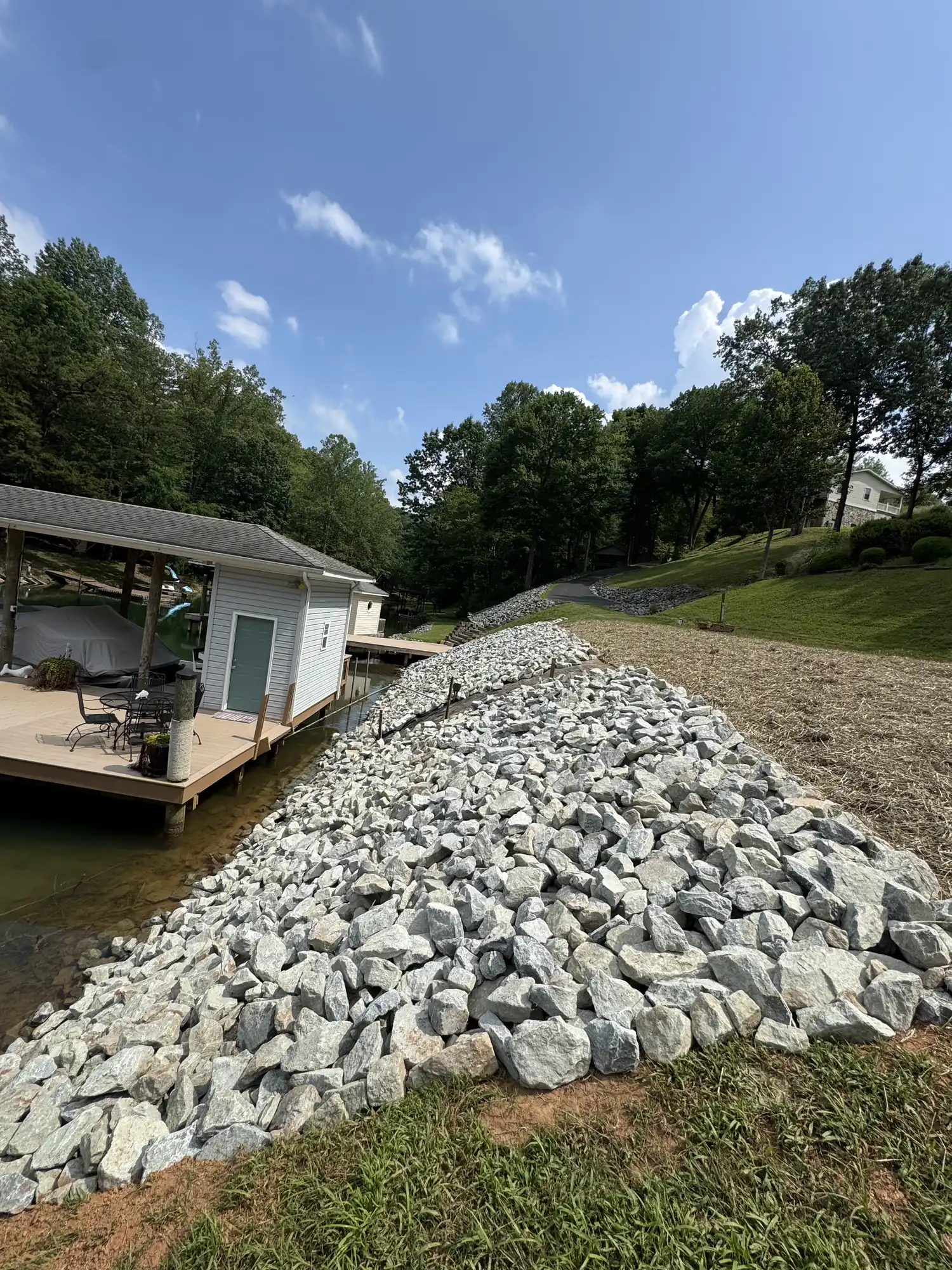 Wide-angle riprap installation showing full project scale
