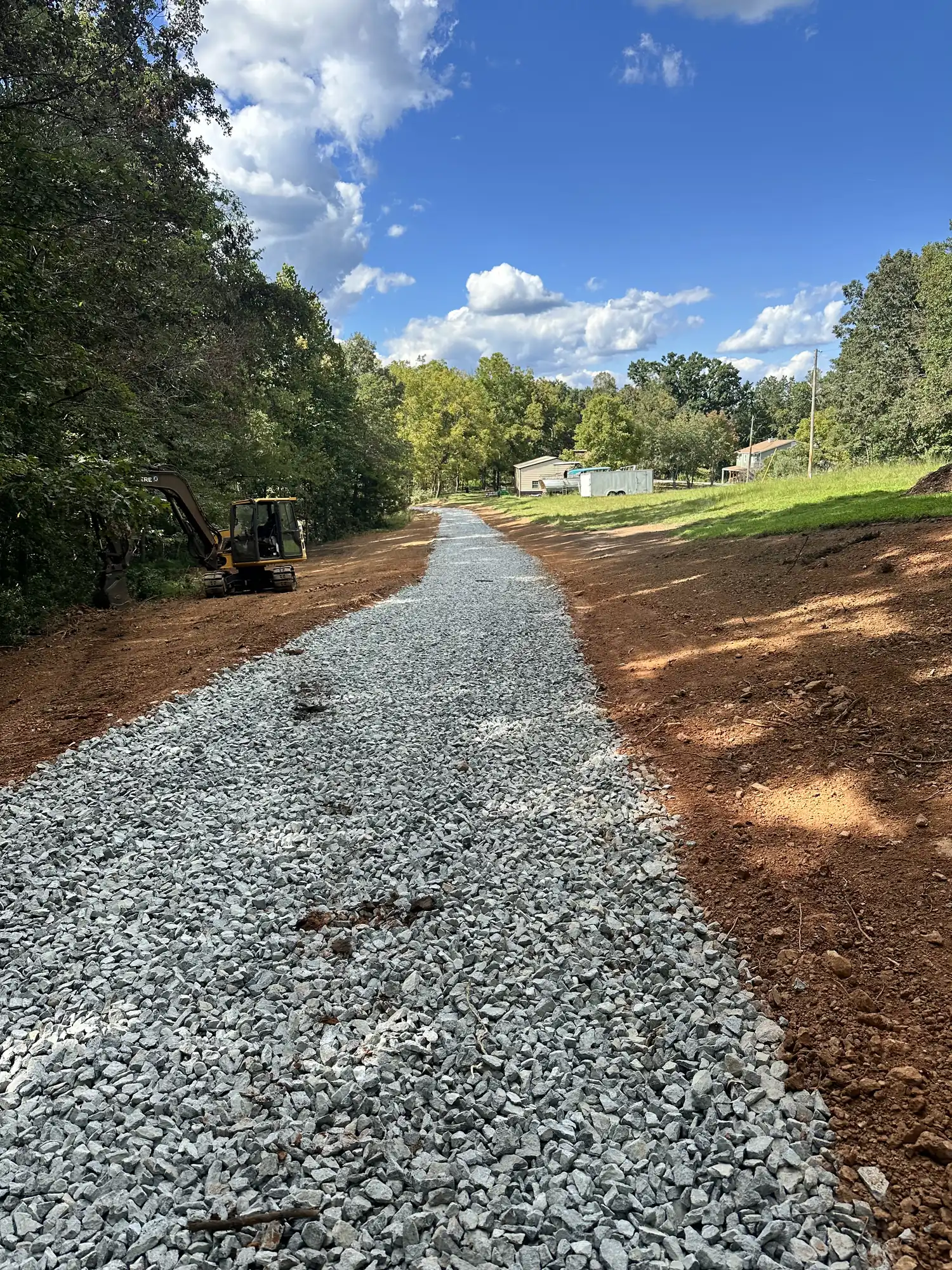 Gravel driveway construction with excavator near Roanoke