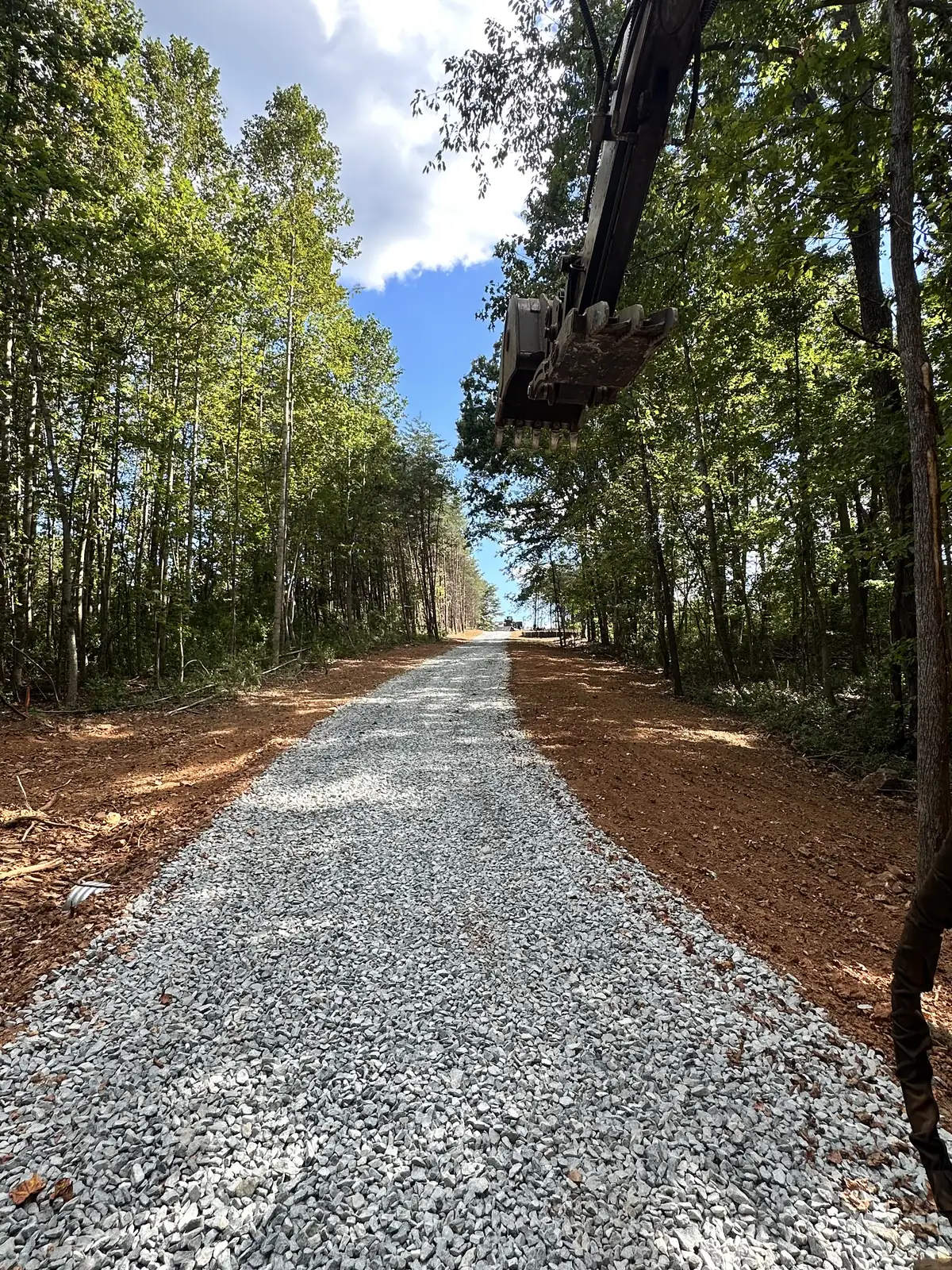 Driveway installation with excavator in action near Roanoke